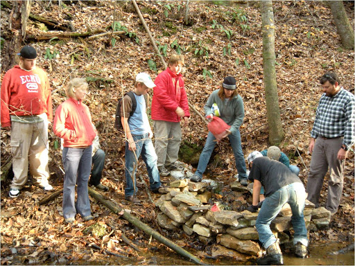 North-Chick-students-at-Ivy-Academy-place-bags-of-limestone-gravel
